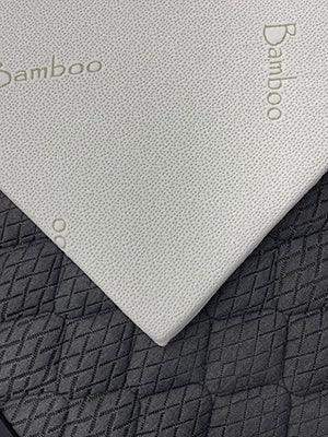 Close-up of bamboo mattress topper on textured mattress surface