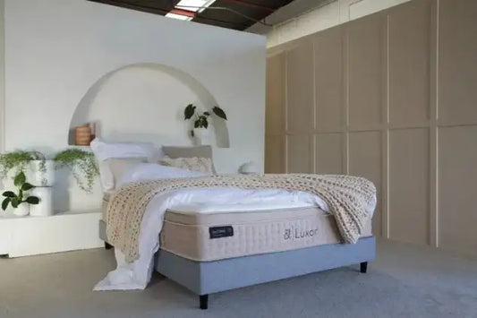 Luxor mattress on a modern bed base in a stylish bedroom with soft bedding and plants