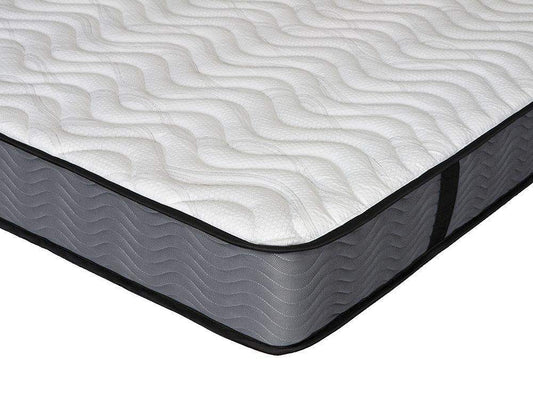 Close-up of modern mattress corner with textured white top and grey fabric sides