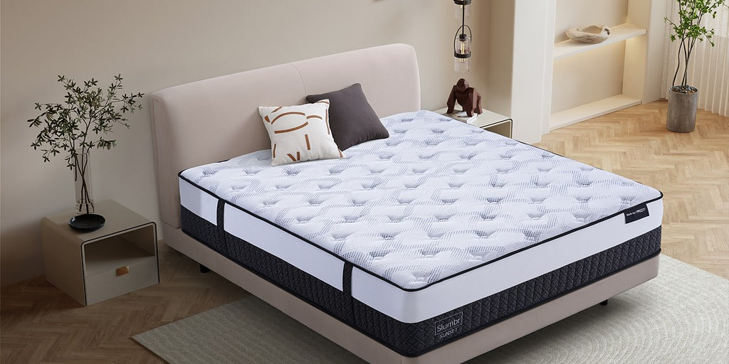 Modern bedroom with a plush queen mattress on an upholstered bed base, decorative pillows