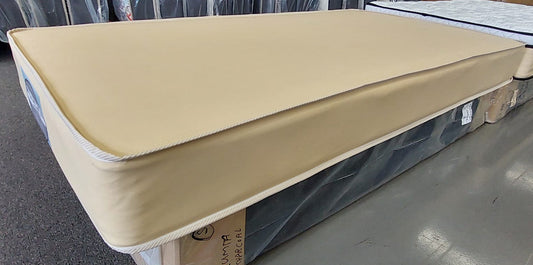 Factory-direct mattress with beige cover on display in a showroom