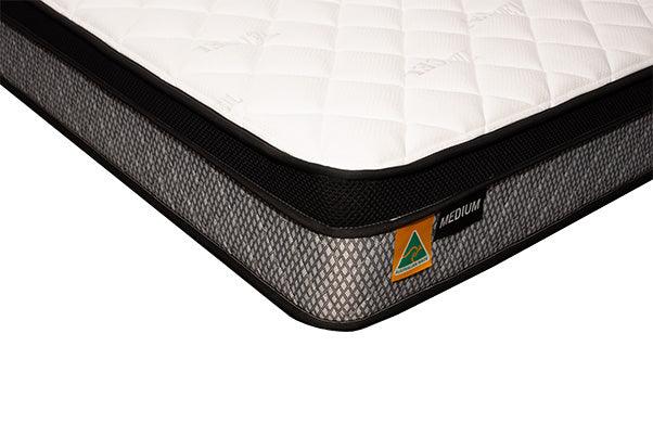 Corner view of a medium firmness mattress with quilted top and Australian made label