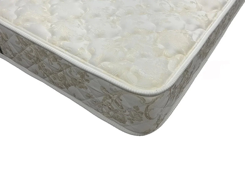 Ultra firm mattress corner with floral patterned fabric and quilted edge