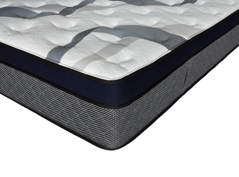 Corner close-up of a gel memory foam mattress with quilted top and grey mesh sides