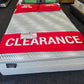 Clearance sale on a Chiropedic mattress in a showroom, red sale signage, discounted price visible.