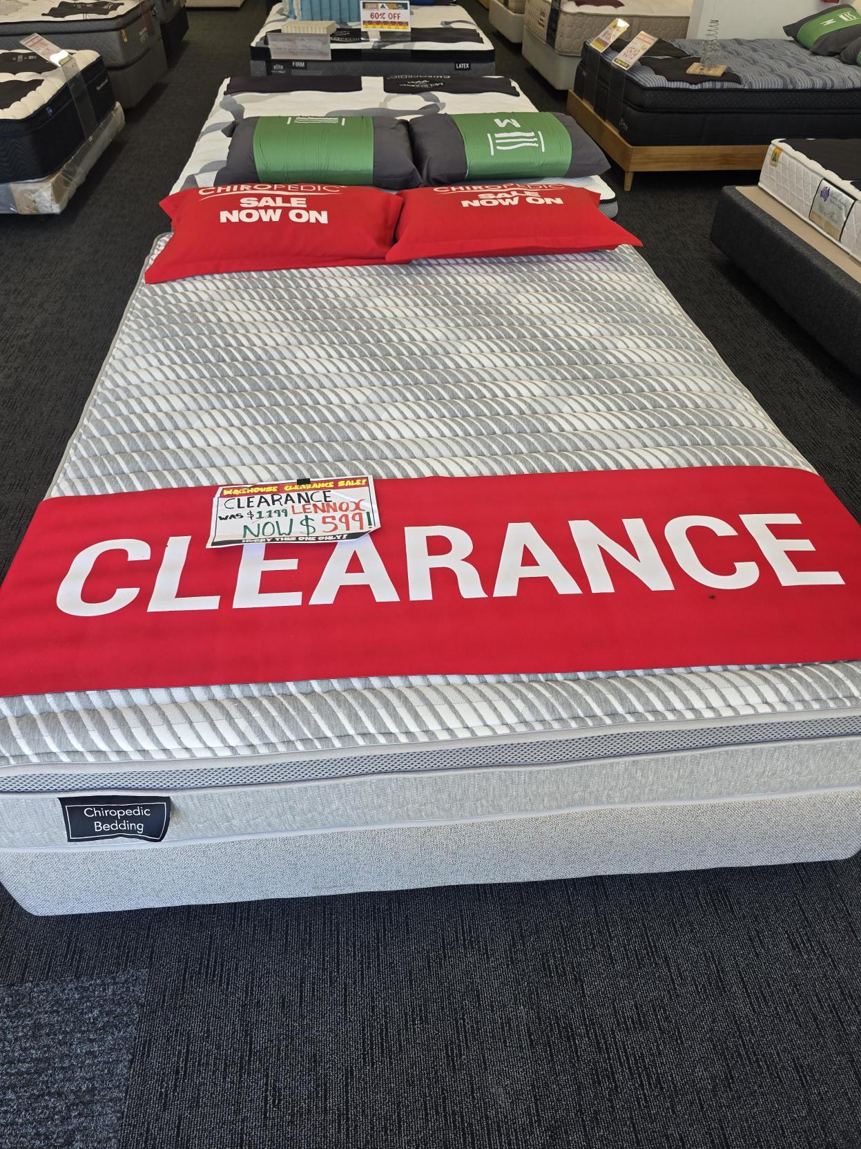 Clearance sale on a Chiropedic mattress in a showroom, red sale signage, discounted price visible.