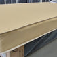 Factory-direct mattress with beige cover on display in a showroom