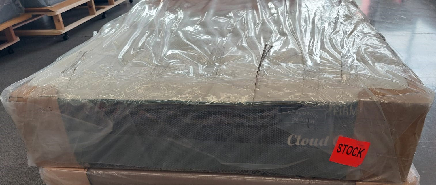 Factory-direct new mattress wrapped in plastic packaging, labeled firm and in stock