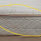 Close-up of a mattress with visible stains on the side, mattress fabric and stitching detail