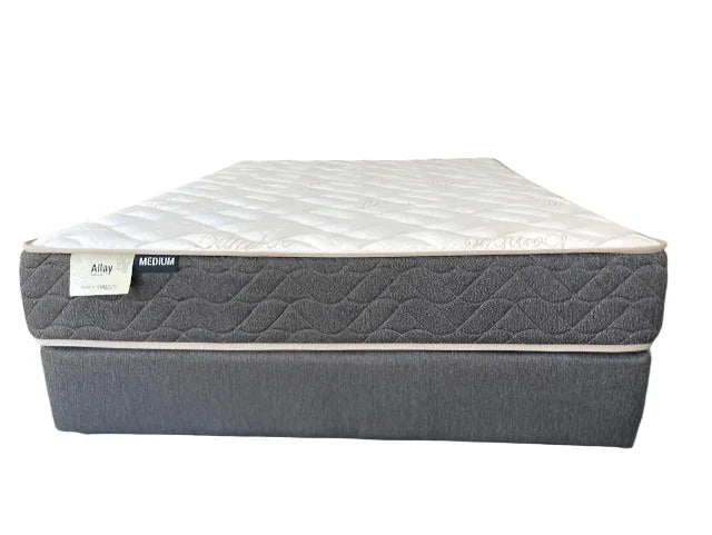 Medium firmness mattress with white quilted top and grey base, bedroom furniture product photo