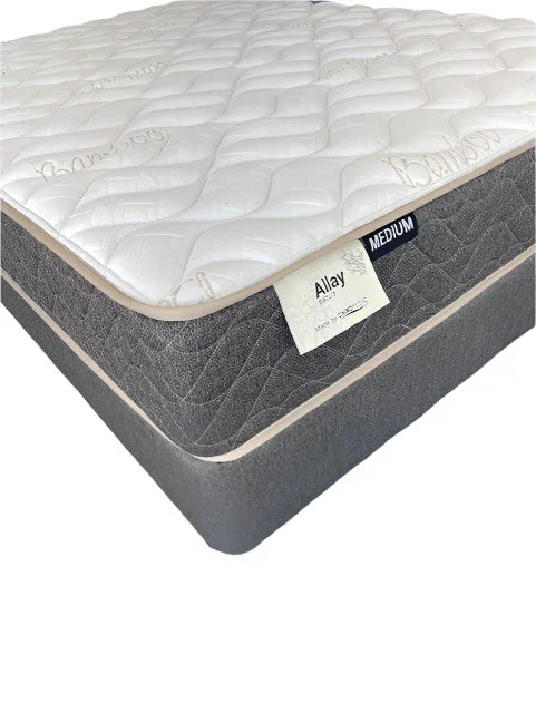 Medium firmness bamboo mattress with quilted white top and grey sides, product tag visible